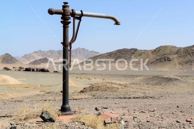 Water column at the ruined station of Huraymil, Saudi-Arabia. Blown up train seen in the background