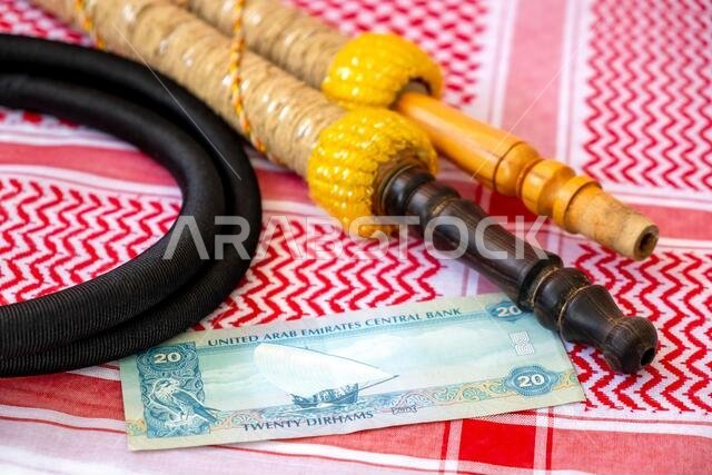 Arab Money Dirham Bank note, , hookah and Traditional Arab Male Clothes - kaffiyah and agal close-up. Arab Money Dirham Bank note, , hookah and Traditional Arab Male Clothes - kaffiyah and agal close-up.