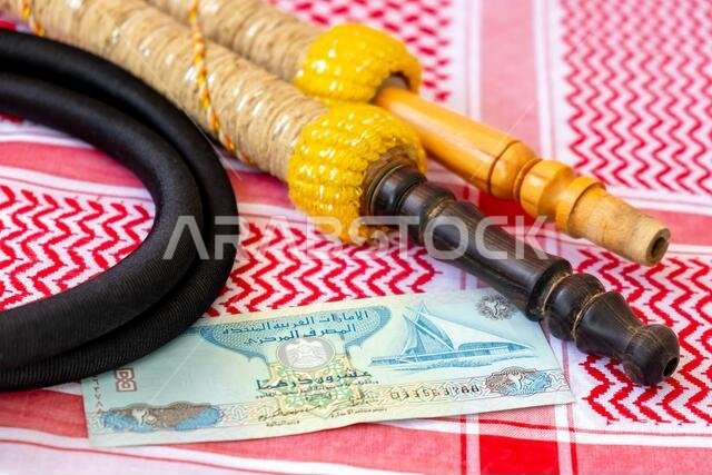 Arab Money Dirham Bank note, , hookah and Traditional Arab Male Clothes - kaffiyah and agal  close-up.