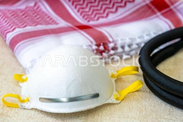 White Protective Mask and Traditional Arab Male Clothes - kaffiyah and agal close-up. White Protective Mask and Traditional Arab Male Clothes - kaffiyah and agal close-up.