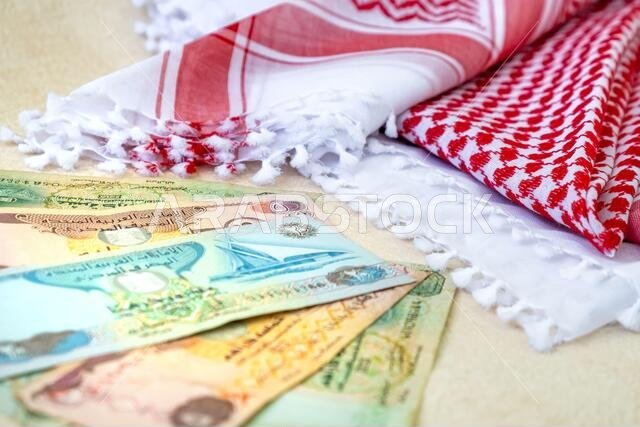 Arab Money Dirham Bank notes  and Traditional Arab Male Scarf - kaffiyah  close-up.