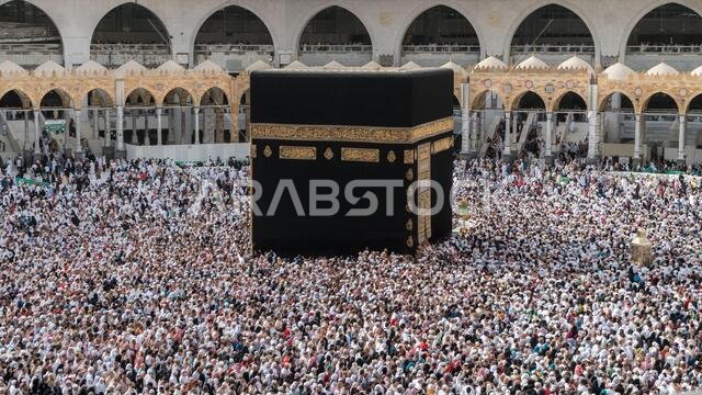 MECCA SAUDI ARABIA JANUARY 28: Muslim pilgrims from all around the World revolving around the Kaaba on January 28 2017 in Mecca Saudi Arabia. Muslim MECCA SAUDI ARABIA JANUARY 28: Muslim pilgrims from all around the World revolving around the Kaaba on January 28 2017 in Mecca Saudi Arabia. Muslim