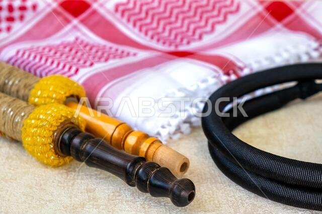 Traditional Arab Male Clothes - kaffiyah, igal, and hookah craft wooden accessories close-up. Traditional Arab Male Clothes - kaffiyah, igal, and hookah craft wooden accessories close-up.