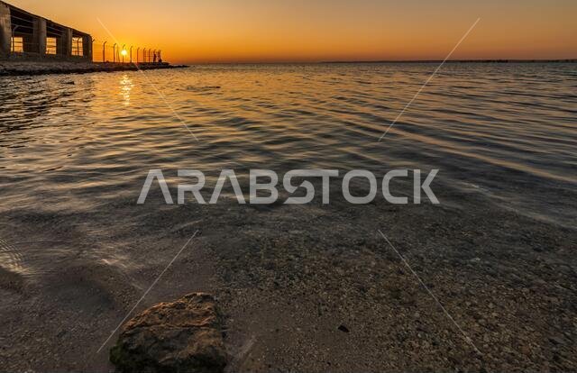 Dramatic sunrise with silky water view in Al uqair ruined fort sea side Saudi Arabia.
