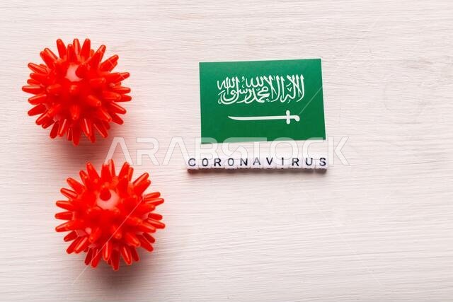 Coronavirus attack concept. Saudi Arabia fight against covid-19. Concept how coronavirus attack on saudi arabia on white background top view.