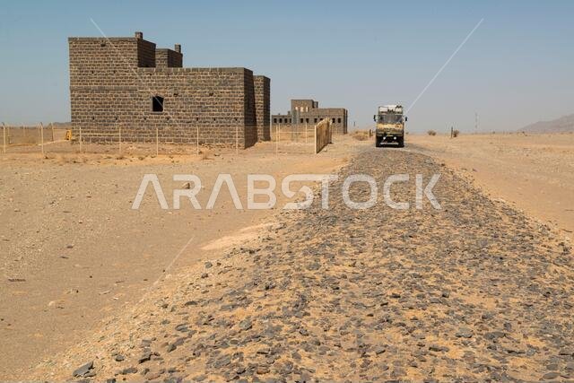 Campertruck parked before an old station on the old track of the Hejaz railway. Saudi-Arabia