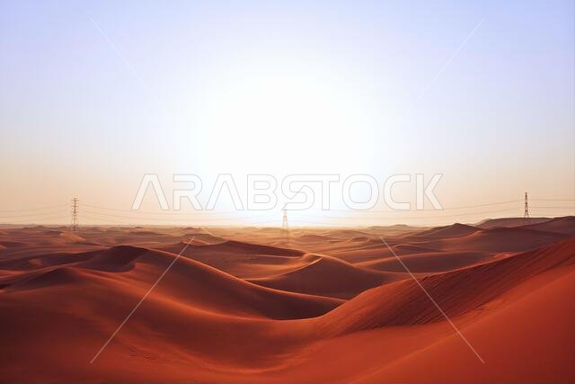 شروق شمس ساطع على الكثبان الرملية الحمراء لصحراء الدهناء في الرياض، المملكة العربية السعودية. بدايات جديدة، رمز للأمل ومستقبل أكثر إشراقاً.