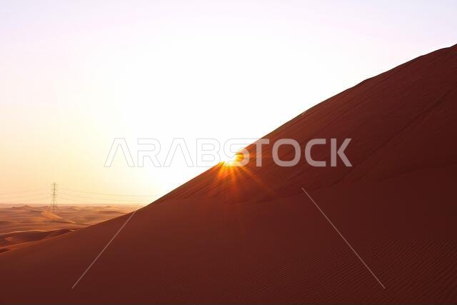 Pastel colored sunrise on the red sand dunes of the Al Dahna Desert in Riyadh, Saudi Arabia. New beginnings, symbol of hope and brighter tomorrow.