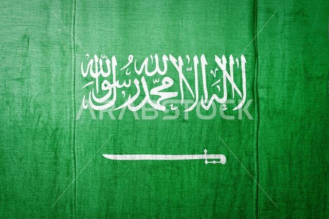 National flag of Saudi Arabia depicting in paint colors on old textile. Flag  banner on  fabric texture background.