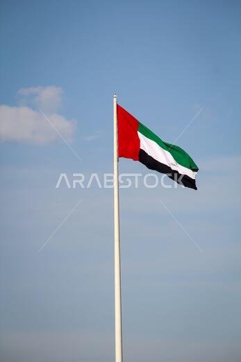 A flag of Saudi Arabia on a flagpole in the wind
