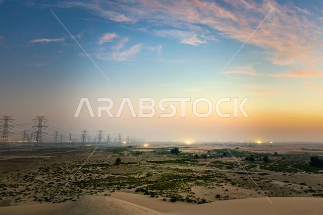 High voltage electric tower on sunrise time near Al Hofuf - Saudi Arabia.