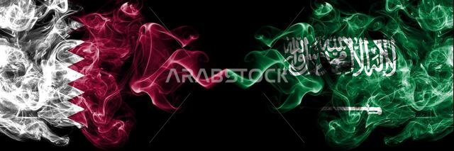 Qatar vs Saudi Arabia, Arabian smoky mystic flags placed side by side. Thick colored silky abstract smoke flags.