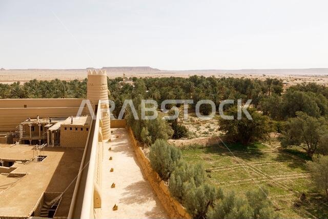 Raghba, Saudi Arabia, February 16 2020: View of the castle wall with corner tower of the castle in Raghba Saudi Arabia. Construction workers are on re