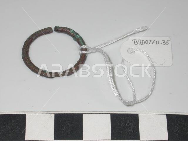 Bronze ring with an opening on one side. Opposite the opening there is a damage on the ring., Ornament, metal, bronze, D 2.4 cm., Saudi Arabia