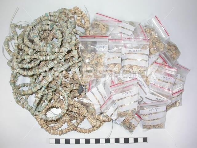44 bags of 15 grams, one bag of 10.40 grams and 13 strings with the lengths: 49, 161, 40, 254, 7, 45, 56.5, 51, 44.5, 44.2, 41.5, 7 and 48.1 cm .. Flat beads, varying in size and color (sand-colored, bluish, brownish, gray, white). Modern laced., Ornament, stone, Saudi Arabia