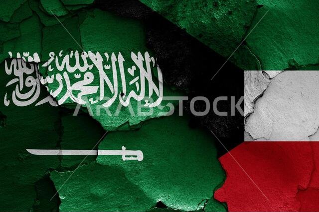 flags of Saudi Arabia and Kuwait painted on cracked wall