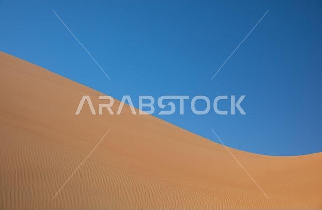 Abstract landscape with desert dunes on a sunny day. Liwa desert, Abu Dhabi, United Arab Emirates.