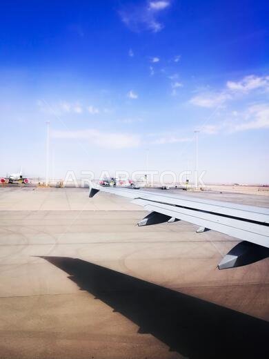 Booking airline Ticket - Airplane window seat showing clouds and wing