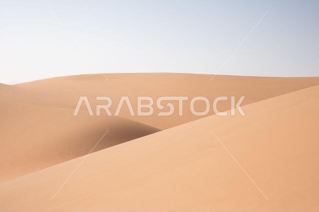 Abstract landscape with desert dunes on a sunny day. Liwa desert, Abu Dhabi, United Arab Emirates.