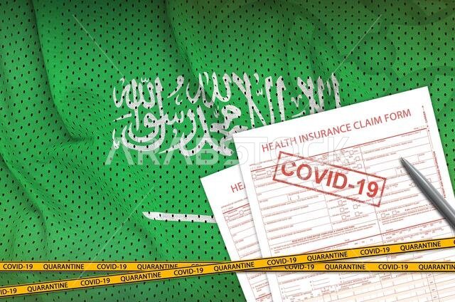 Saudi Arabia flag and Health insurance claim form with covid-19 stamp. Coronavirus or pandemic 2019-nCov virus concept