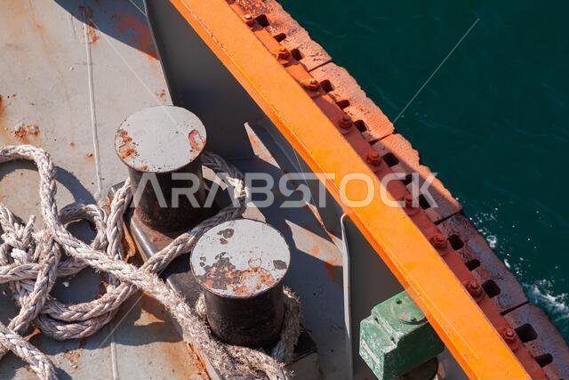 Bollard with mooring ropes are on a tug boat deck