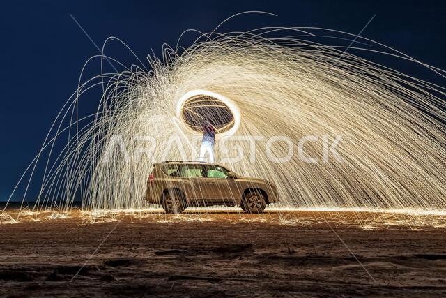 A steel wool on fire at night (night photography using a slow shutter speed) - selective focused.