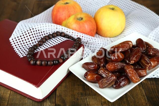 لوحة فنية تضم أطعمة رمضانية تقليدية، على خلفية خشبية.