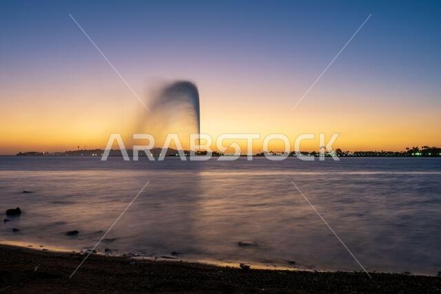 Panoramic view of the King Fahd's Fountain seen from the South Corniche, Jeddah, Saudi Arabia, with a beautiful sunset in the background