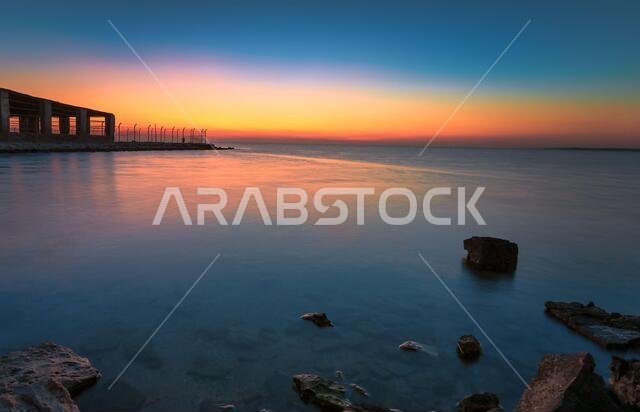 Dramatic sunrise with silky water view in Al uqair ruined fort sea side Saudi Arabia.