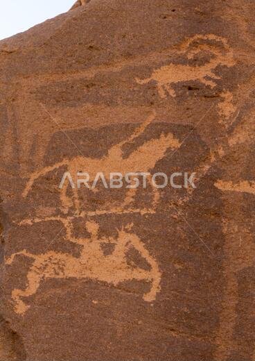 Petroglyphs on a rock depicting hunters, Najran Province, Thar, Saudi Arabia