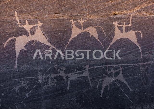 Petroglyphs on a rock depicting men hunting on horses, Najran Province, Minshaf, Saudi Arabia