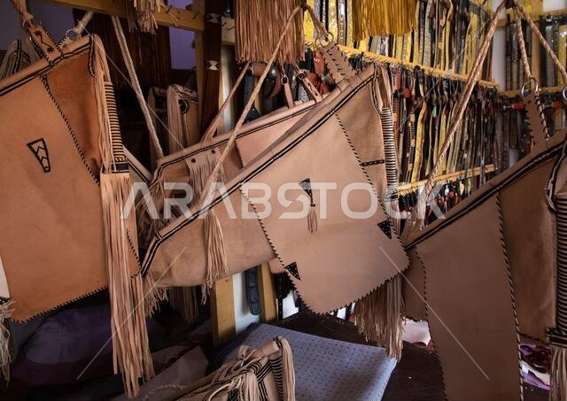Traditional leather cradles with fringes for sale in a shop, Najran Province, Najran, Saudi Arabia