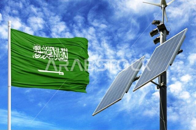 Solar panels on a background of blue sky with a flagpole and the flag of Saudi Arabia