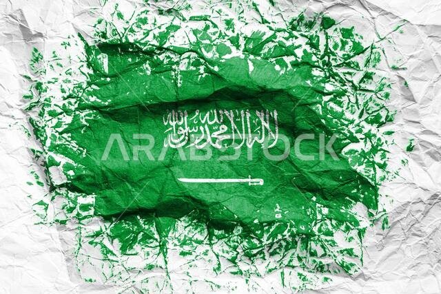 The national flag of the Saudi Arabia  is painted on crumpled paper. Flag printed on the sheet. Flag image for design on flyers, advertising.