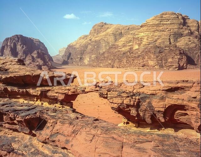 Jordan. Colourful desert mountain landscapes at the rock arch of Al Kharza at the UNESCO World Heritage Site of Wadi Rum near the port of Aqaba in southern Jordan