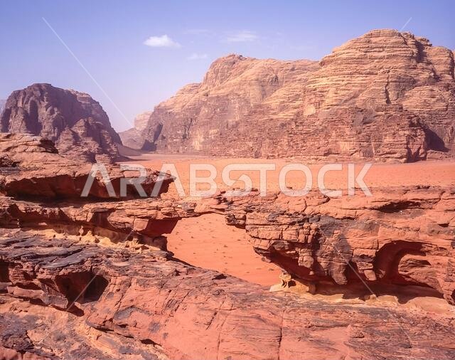 Jordan. Colourful desert mountain landscapes at the rock arch of Al Kharza at the UNESCO World Heritage Site of Wadi Rum near the port of Aqaba in southern Jordan