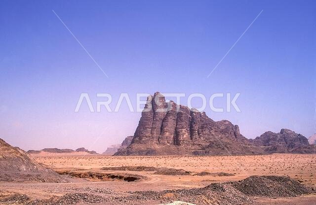 Jordan. Colourful scenes at the UNESCO World Heritage Site of Wadi Rum near the port of Aqaba in southern Jordan looking towards the Seven Pillars of Wisdom mountain associated with Lawrence of Arabia.