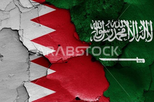 flags of Bahrain and Saudi Arabia painted on cracked wall