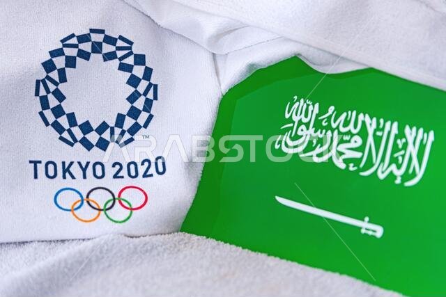 TOKYO, JAPAN, FEBRUARY. 4, 2020: Saudi Arabia National flag, official logo of summer olympic games in Tokyo 2020. White background