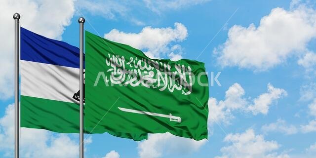 Lesotho and Saudi Arabia flag waving in the wind against white cloudy blue sky together. Diplomacy concept, international relations.