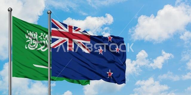 Saudi Arabia and New Zealand flag waving in the wind against white cloudy blue sky together. Diplomacy concept, international relations.