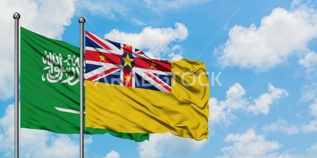 Saudi Arabia and Niue flag waving in the wind against white cloudy blue sky together. Diplomacy concept, international relations.