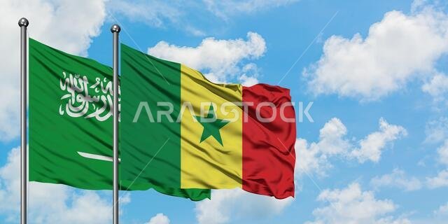Saudi Arabia and Senegal flag waving in the wind against white cloudy blue sky together. Diplomacy concept, international relations.