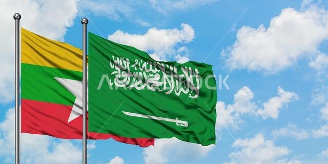 Myanmar and Saudi Arabia flag waving in the wind against white cloudy blue sky together. Diplomacy concept, international relations.