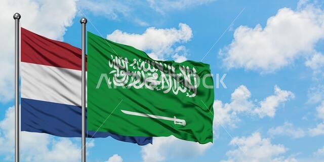 Netherlands and Saudi Arabia flag waving in the wind against white cloudy blue sky together. Diplomacy concept, international relations.