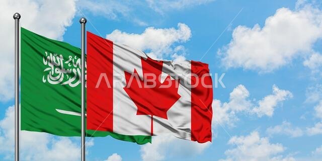 Saudi Arabia and Canada flag waving in the wind against white cloudy blue sky together. Diplomacy concept, international relations.