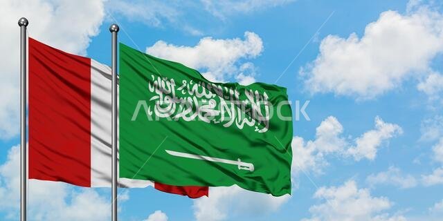 Peru and Saudi Arabia flag waving in the wind against white cloudy blue sky together. Diplomacy concept, international relations.