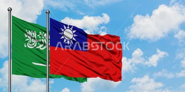 Saudi Arabia and Taiwan flag waving in the wind against white cloudy blue sky together. Diplomacy concept, international relations.