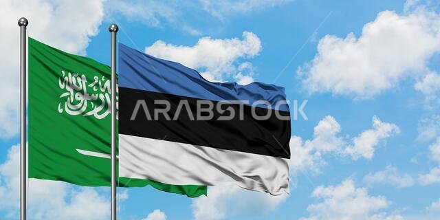 Saudi Arabia and Estonia flag waving in the wind against white cloudy blue sky together. Diplomacy concept, international relations.