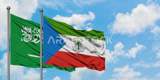 يرفرف علم المملكة العربية السعودية وعلم غينيا الاستوائية معاً في مهب الريح أمام سماء زرقاء صافية تتلألأ فيها الغيوم البيضاء. مفهوم الدبلوماسية، العلاقات الدولية. يرفرف علم المملكة العربية السعودية وعلم غينيا الاستوائية معاً في مهب الريح أمام سماء زرقاء صافية تتلألأ فيها الغيوم البيضاء. مفهوم الدبلوماسية، العلاقات الدولية.